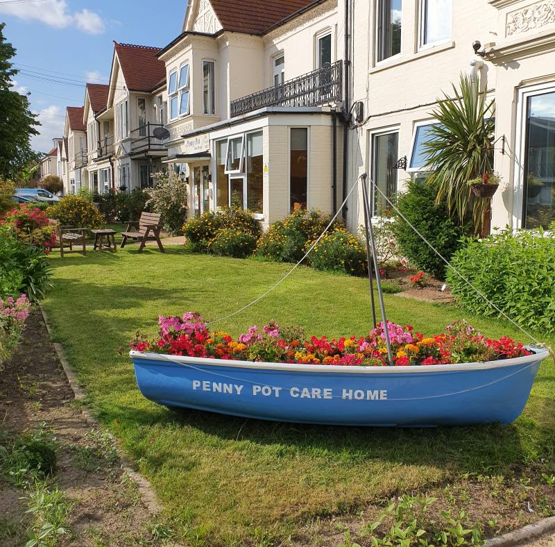 Front of Penny Pot Care Home in Clacton with flowers in boat